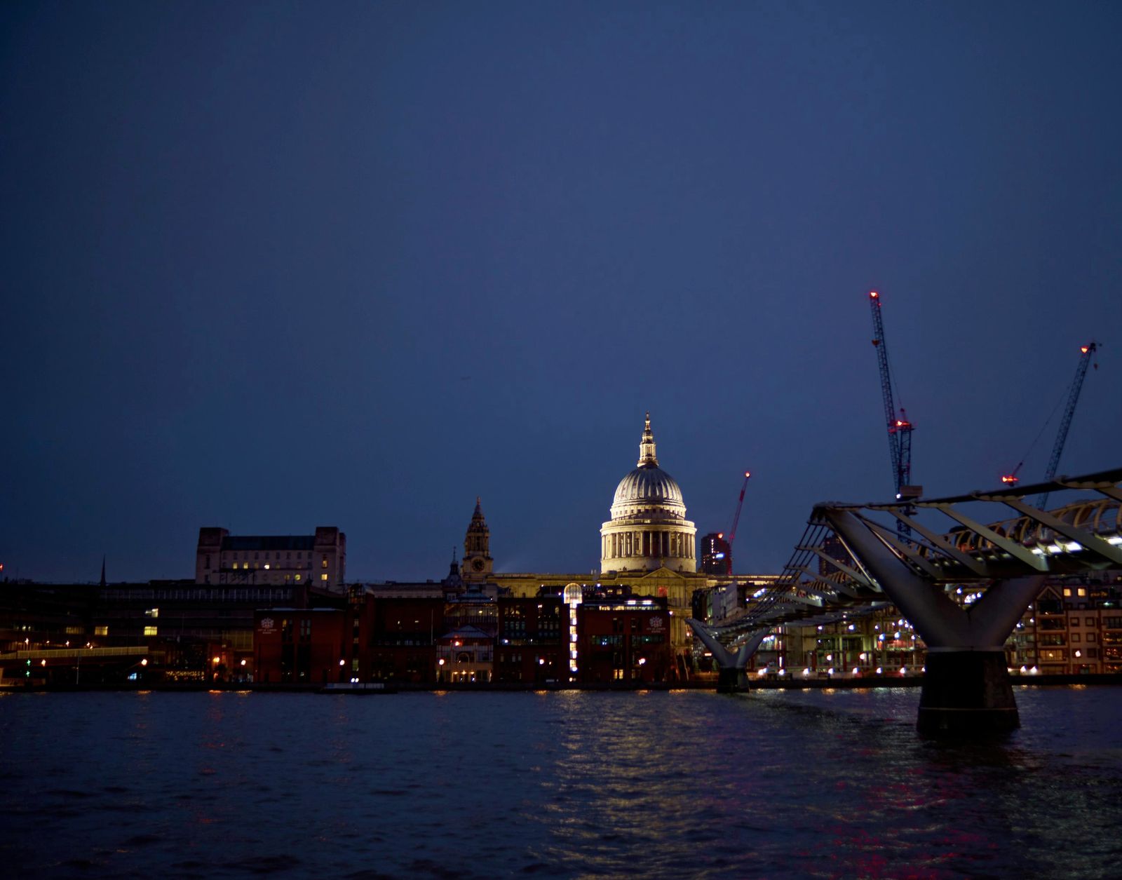 St Paul's Cathedral and the Millennium Bridge across the Thames at dusk